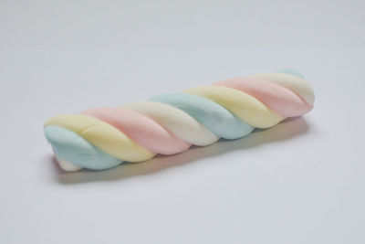 Close-up of multi colored candies against white background