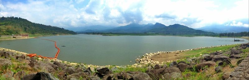 Scenic view of lake against cloudy sky