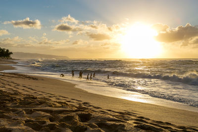 Scenic view of beach against sky during sunset