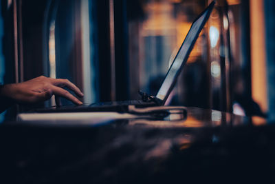 Midsection of woman using laptop