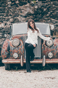 Full length portrait of woman in car