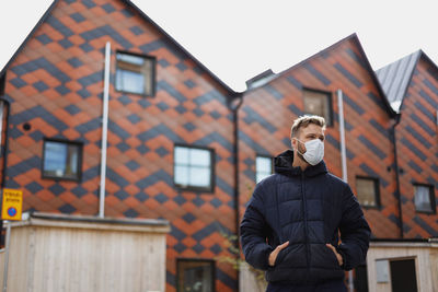 Man wearing face mask looking away