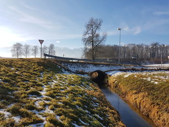 Bridge over river against sky during winter