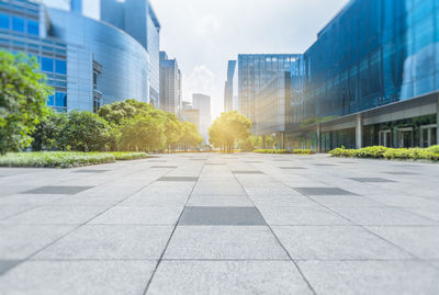 Surface level of road amidst buildings against sky