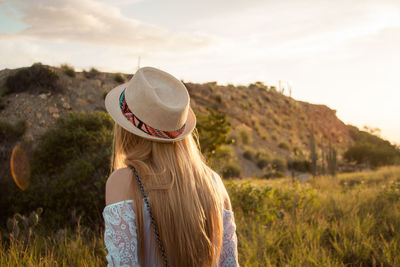 Woman wearing hat against mountains