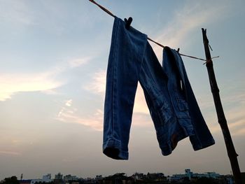 Low angle view of clothes drying on clothesline against sky