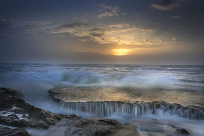 Scenic view of sea against sky during sunset