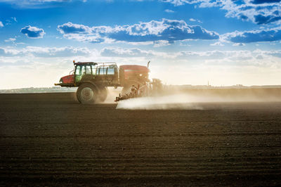 Tractor on field against sky