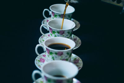 Close-up of tea cup against black background