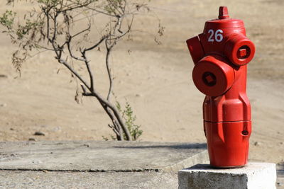 Close-up of fire hydrant against wall in city