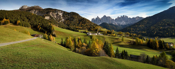 Scenic view of field and mountains against sky