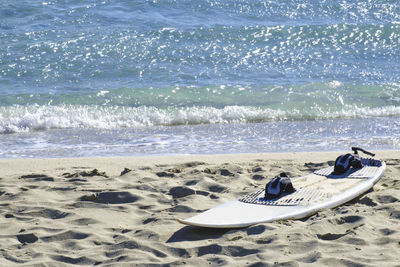 Surfboard on shore at beach