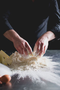 Cropped view of chef's hands making pastry