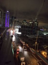 Illuminated cityscape against sky at night