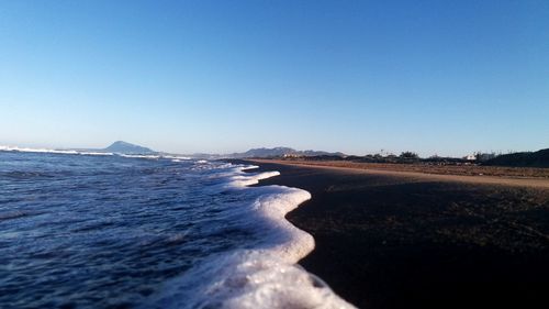 Scenic view of sea against clear blue sky