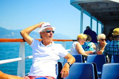 Friends enjoying on boat sailing in sea