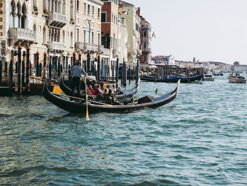 Boats in canal along buildings