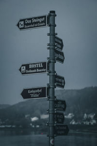 Low angle view of road sign against sky