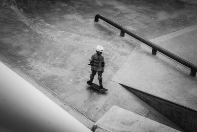 Full length of boy skateboarding at park