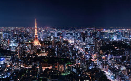 Aerial view of city lit up at night
