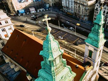 High angle view of statue amidst buildings in city