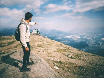 Full length of man standing on mountain against sky