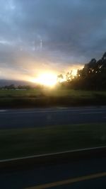 Scenic view of field against sky at sunset