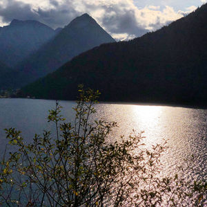 Scenic view of sea and mountains against sky