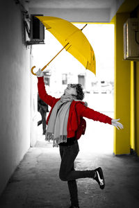Rear view of man with red umbrella