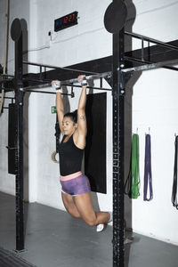 Full length of woman exercising in gym