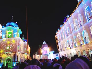 Group of people in front of building at night