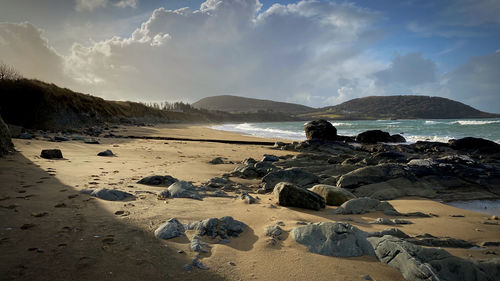 Panoramic view of rocks on beach against sky