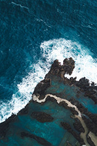 Top down view of a natural pool next to the sea.