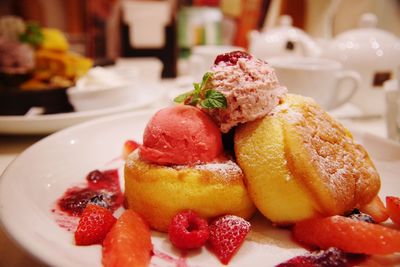 Close-up of fresh dessert and berry fruits served in plate on table at restaurant