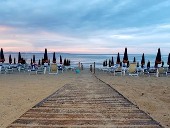 Scenic view of beach against sky during sunset