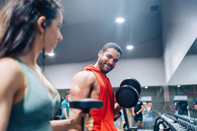 Portrait of couple love in fitness training with dumbbell equipment.