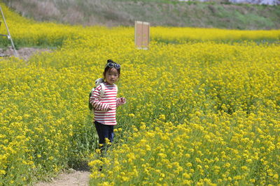 Girl standing in flower field