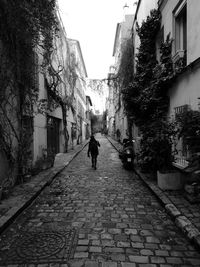 Rear view of woman walking on street in city