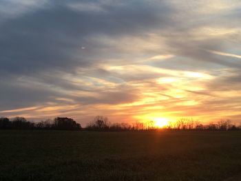 Scenic view of dramatic sky over field