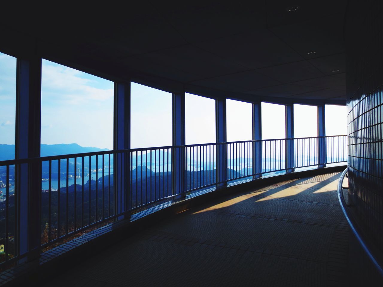 indoors, sea, sky, window, built structure, transportation, horizon over water, architecture, glass - material, beach, water, day, empty, transparent, no people, railing, sunlight, architectural column, nature, travel