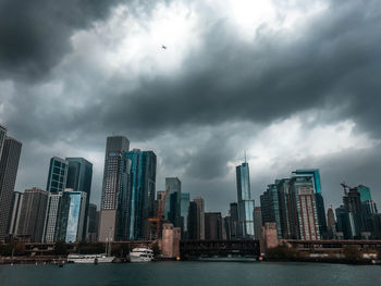 View of skyscrapers against cloudy sky