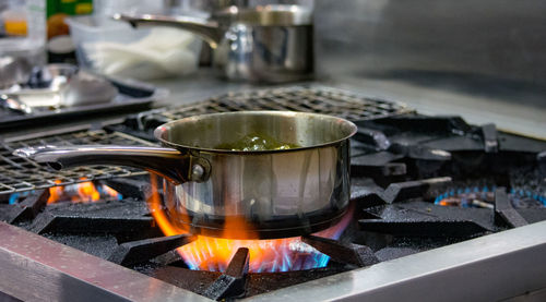 Close-up of preparing food on barbecue grill at home