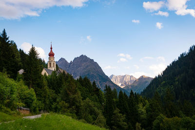 Panoramic view of trees and buildings against sky