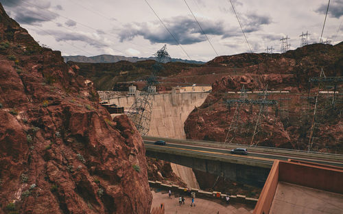Scenic view of dam on mountain against sky
