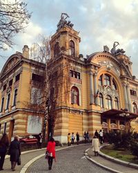 People in front of historical building