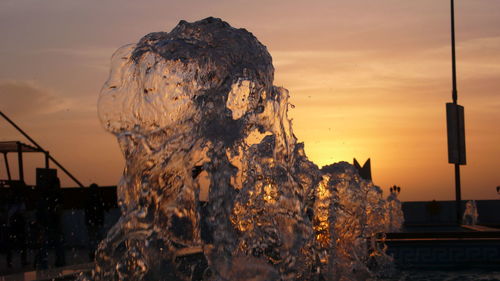 Close-up of fountain against sky at sunset