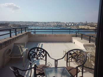 View of swimming pool by sea against sky