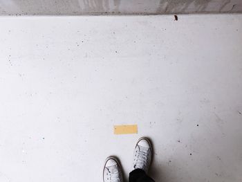 Low section of man standing on floor