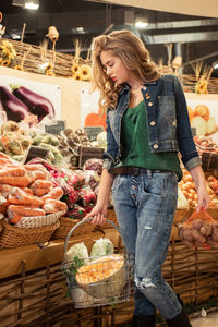 Portrait of woman with vegetables for sale at market