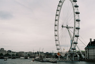 Low angle view of ferris wheel against sky